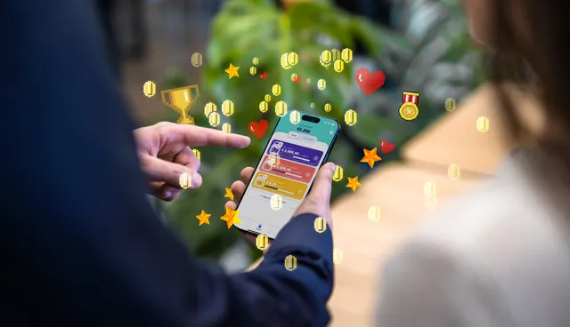 Image of a mobile app with game elements flying around it.