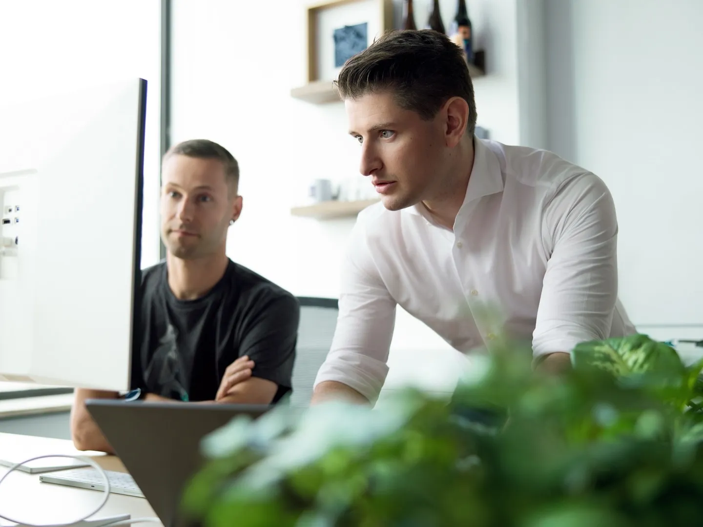 Two colleagues looking at a monitor together