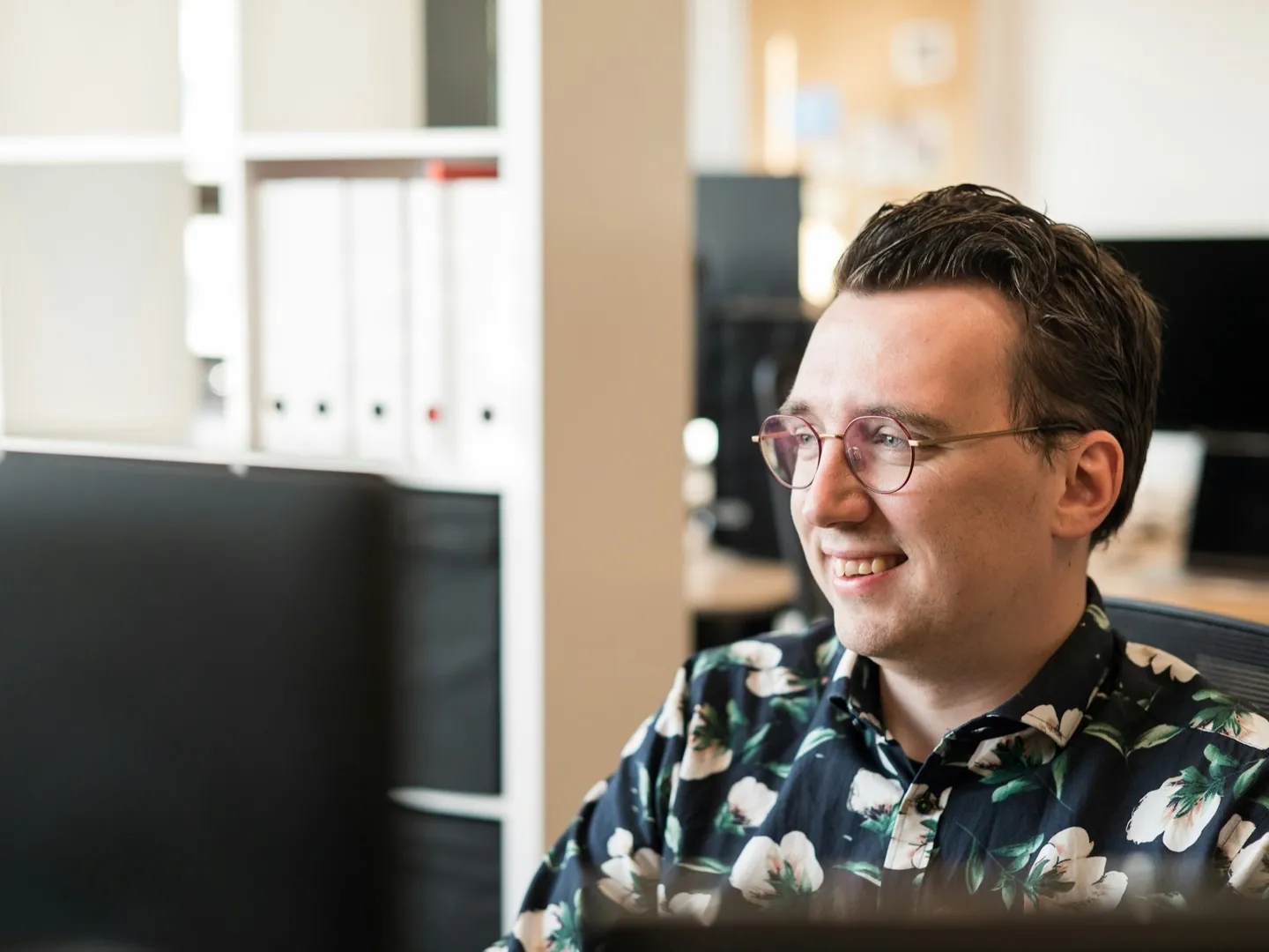 A developer behind a monitor in the office
